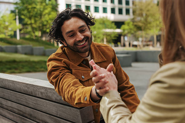 istock Young man shaking hands with a colleague in a city park 2217809509