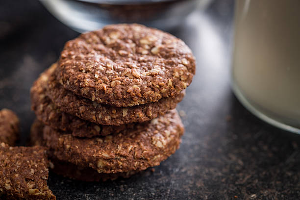 Sweet oatmeal cookies on a black table.