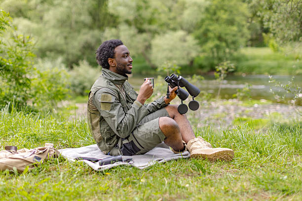 istock Young man enjoying bird watching in a lush forest on a cheerful weekend adventure 2217809954