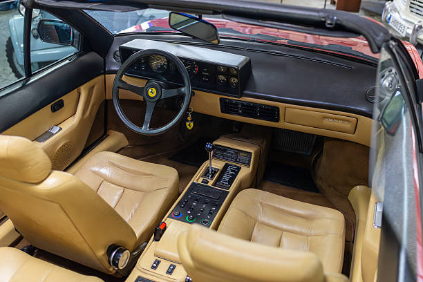 Panevezys, Lithuania - July 16, 2024: Interior shot of a classic Ferrari Mondial Cabriolet Quattrovalvole. Very nice presented beige leather interior with manual gearbox and classical three spoke steering wheel.