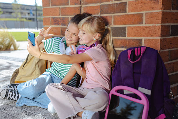 istock Two happy friends taking a selfie outdoors during a school break 2217810115