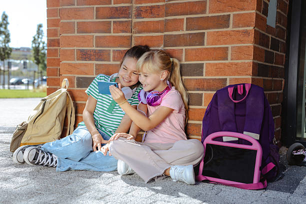 istock Two happy friends taking a selfie outdoors during a school break 2217810118