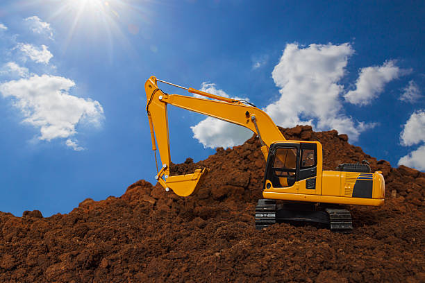 istock Yellow excavators are digging the soil in the construction site . 2217811007