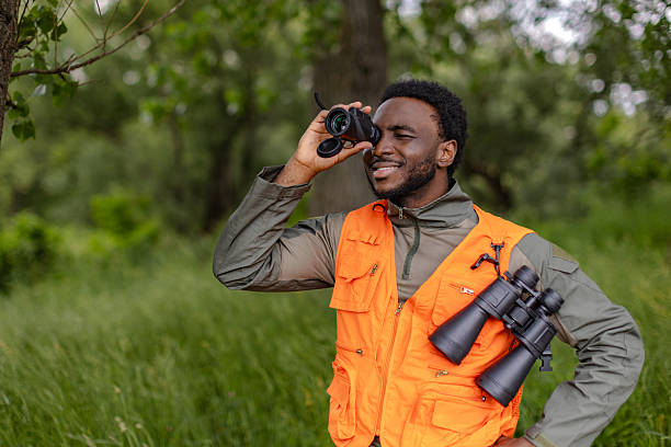 istock Young man enjoys bird watching in a lush forest during a weekend outdoor adventure 2217811018