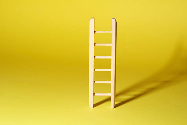 istock close of ladder on  yellow background 2217812065