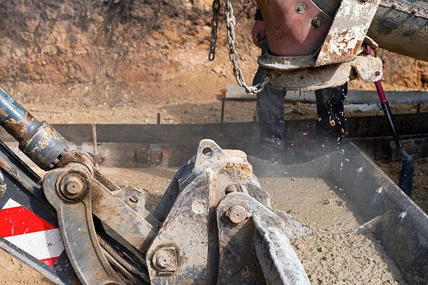 istock Construction workers pouring concrete on job site straight from delivery truck 2217812546