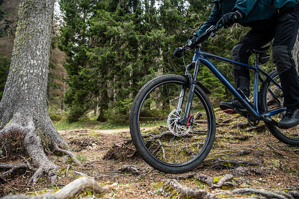 istock Man mountain biking forest bike trails Close Up 2217812586