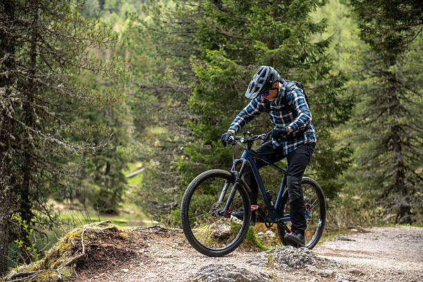 istock Man mountain biking forest bike trails 2217812630
