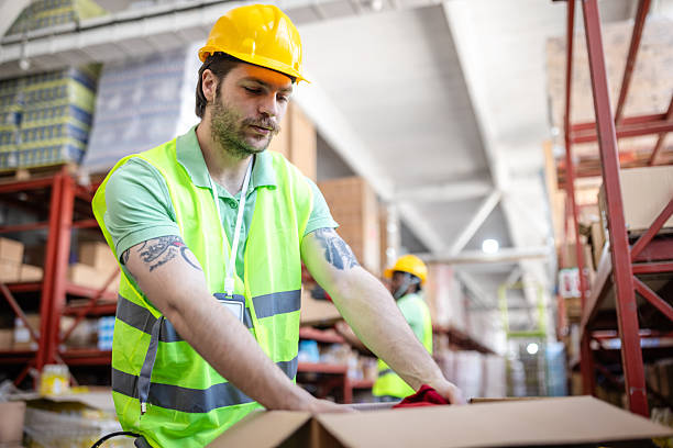 istock Warehouse workers packaging merchandise in a busy distribution center during daytime hours 2217813283