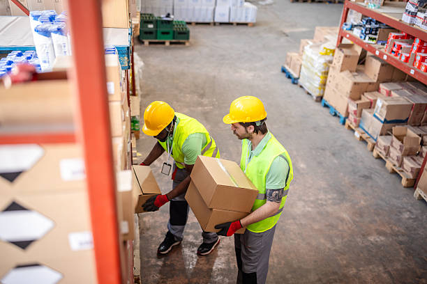 istock Warehouse workers handling boxes in a distribution center during business hours 2217814919