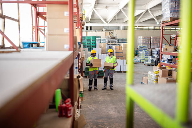 istock Warehouse workers handle merchandise in a busy distribution center during the day 2217815151