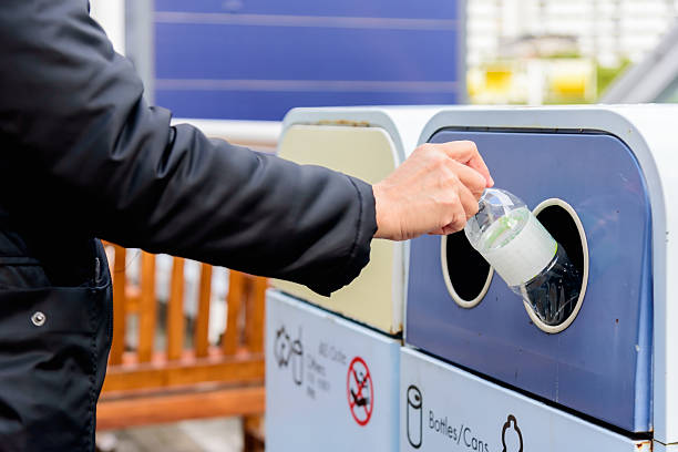istock Putting a plastic bottle in a garbage recycling bin, waste recycling, sorting garbage concept. 2217815480