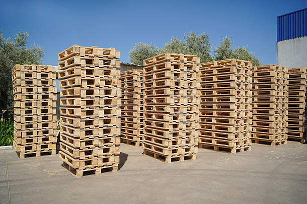 istock Stacked Wooden Pallets Outdoors in a Storage Facility on a Sunny Day. 2217815645