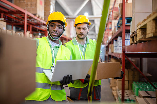 istock Warehouse workers examining inventory and managing operations during a busy day in a distribution center 2217815745