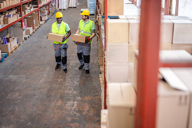 istock Warehouse workers examining boxes in a busy distribution center during daytime operations 2217815926