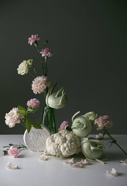unusual composition of flowers, vegetables and cheese