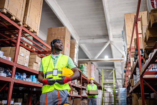 istock Warehouse workers examine merchandise and ensure proper packaging in a distribution center during a busy work shift 2217816084