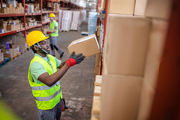 istock Warehouse workers engage in packaging and inspecting merchandise in a busy distribution facility during daylight hours 2217816362