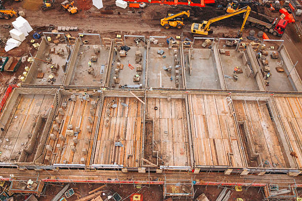 istock Aerial view from drone at Heavy machinery and workers are busy at a construction site where a multi-story building frame is being erected 2217816372