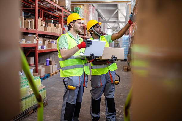 istock Warehouse workers engage in inspecting and organizing merchandise in a busy distribution center during daytime operations 2217816445