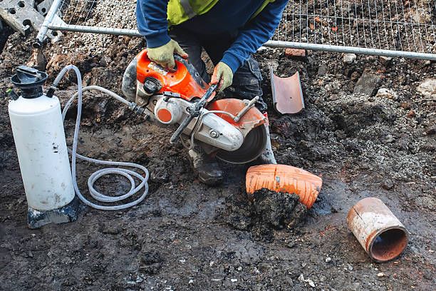 istock Construction worker cutting clay drainage pipes at building site with power saw and diamond blade 2217816688