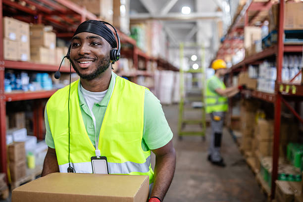 istock Warehouse workers efficiently organizing and shipping e-commerce products in a busy distribution center 2217816812