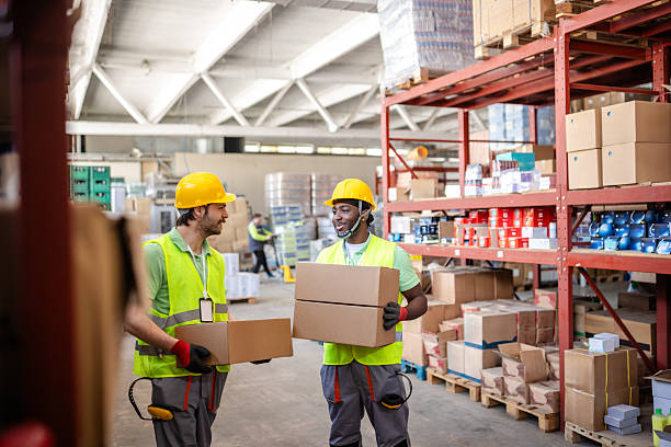 istock Warehouse workers efficiently handling packages in a distribution center during busy work hours 2217817056