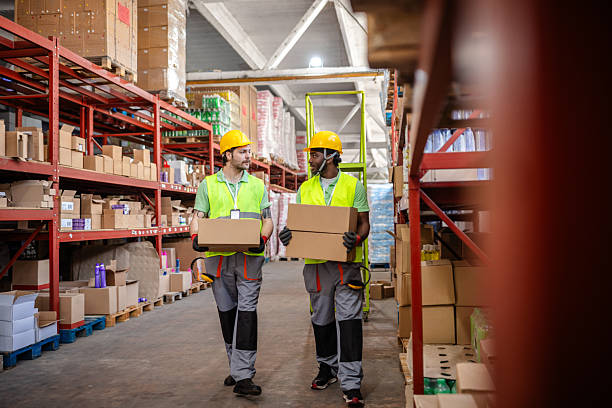 istock Warehouse workers collaborating to manage inventory in a busy distribution center 2217817407