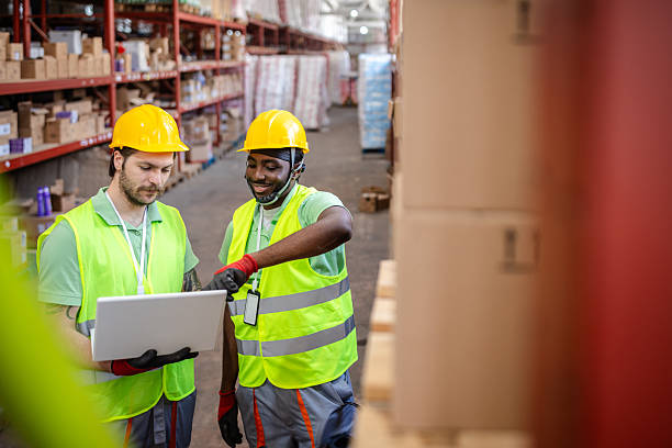 istock Warehouse workers collaborating on logistics with digital equipment in a distribution center 2217818277
