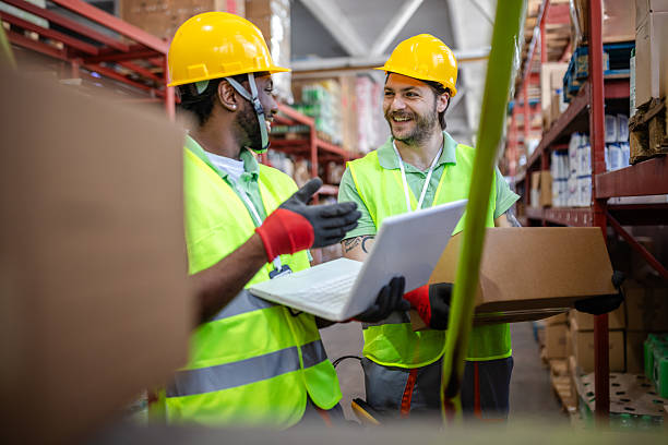 istock Warehouse workers collaborating on inventory management in a busy distribution center during the day 2217818423