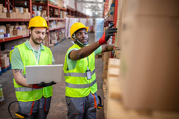 istock Warehouse workers collaborate on inventory management in a busy distribution center 2217818864