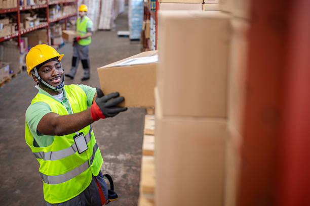 istock Warehouse workers actively managing packages in a busy distribution facility 2217819009