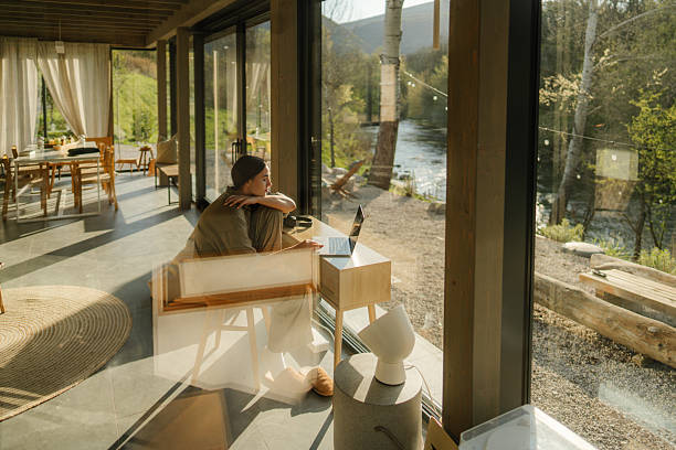 istock Working from my weekend cottage house, overlooking the river 2217821489
