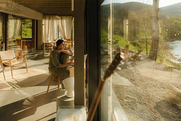 istock Working from my weekend cottage house, overlooking the river 2217821526