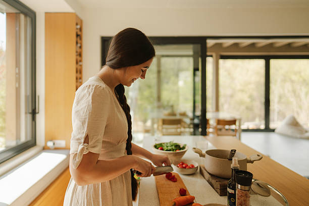istock Young woman's preparing home-cooked meal 2217821535