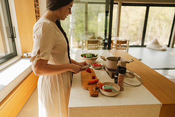 istock Young woman's preparing home-cooked meal 2217821536
