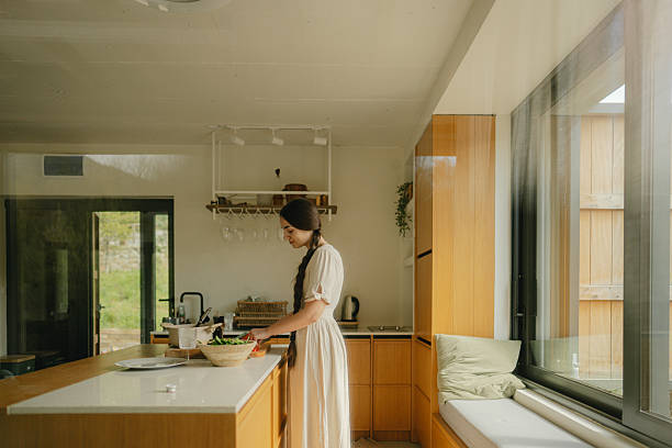 istock Young woman's preparing home-cooked meal 2217821544