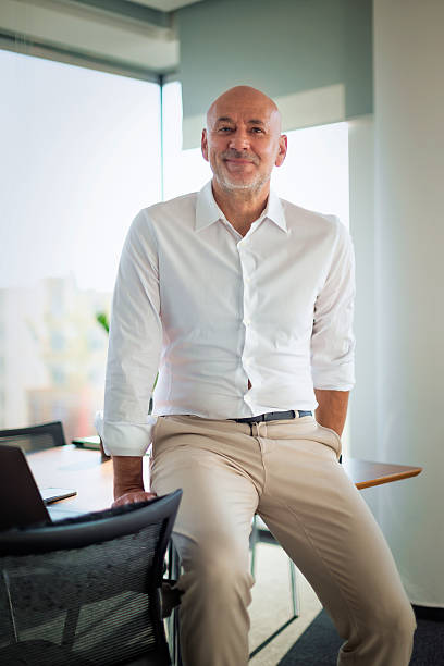 istock Senior man standing at desk in a modern office 2217823267
