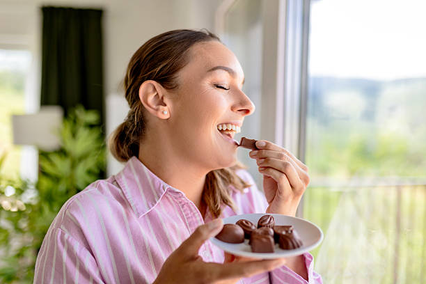 istock Woman Savoring a Chocolate Snack 2217823382