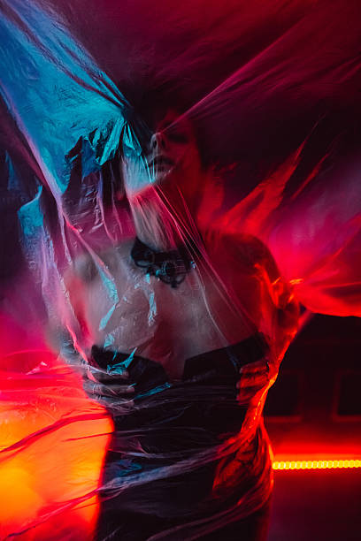 istock Young Woman Underneath The Plastic Under Red Neon Lights 2217826130
