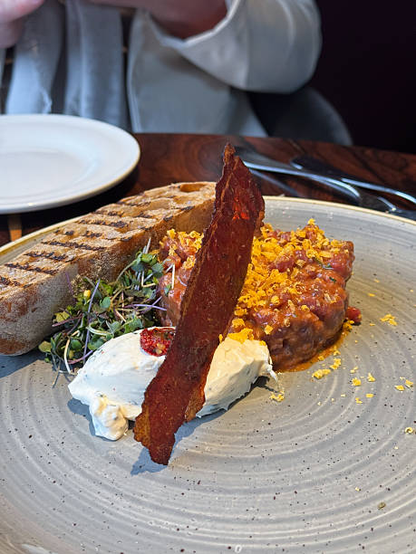 Gourmet food Beef Tartare with egg, herbs, chives and truffle cream in elegant restaurant