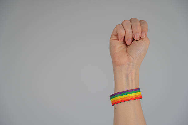 istock Woman's fist with rainbow bracelet. 2217827767