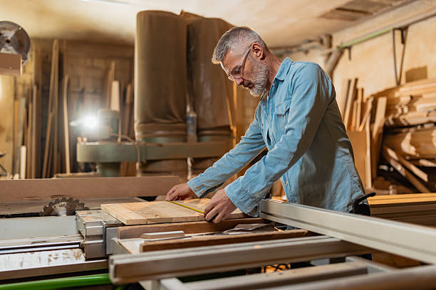 istock Carpenter at Work with Measuring Tape in Hand 2217828769