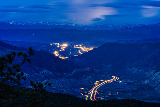 Gypsum Dotsero Colorado at Night with Interstate 70 Running Along Valley - Scenic view during blue hour with long exposure light trails, Eagle and Colorado River and towns of Gypsum and Dotsero glowing during dusk.