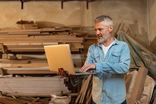 istock Man Working on Laptop in Woodworking Shop Space 2217828873