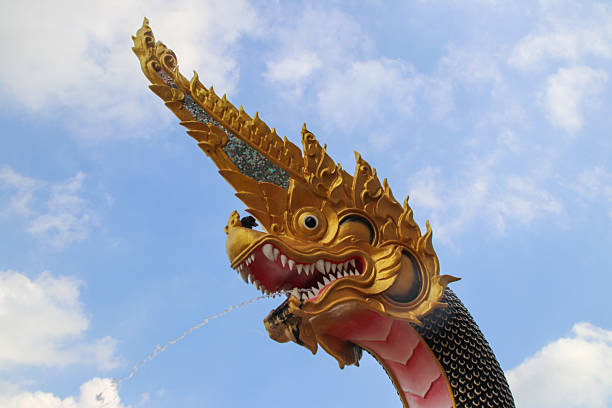 Golden dragon spitting water from its mouth at Wat Saman Rattanaram, Chachoengsao, Thailand