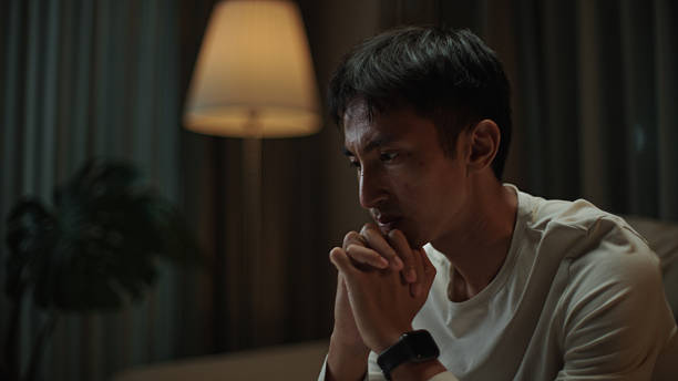 istock Asian man worried at night. 2217829932