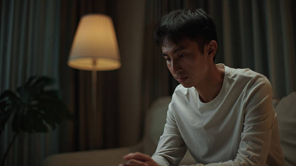 istock Asian man worried at night. 2217829936