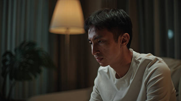 istock Asian man worried at night. 2217829940