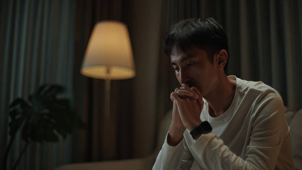 istock Asian man worried at night. 2217829942